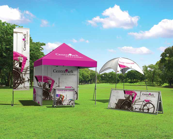 An outdoor business display featuring flags, tents, signs and kiosks.