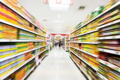 Store shelves in an aisle that are blurred to indicate a sea of products without any point-of-purchase displays. 