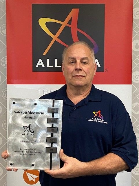 Allegra co-owner Mike Logan was presented with an award from Allegra Franchise Brands for achieving top ten ranking in sales growth.