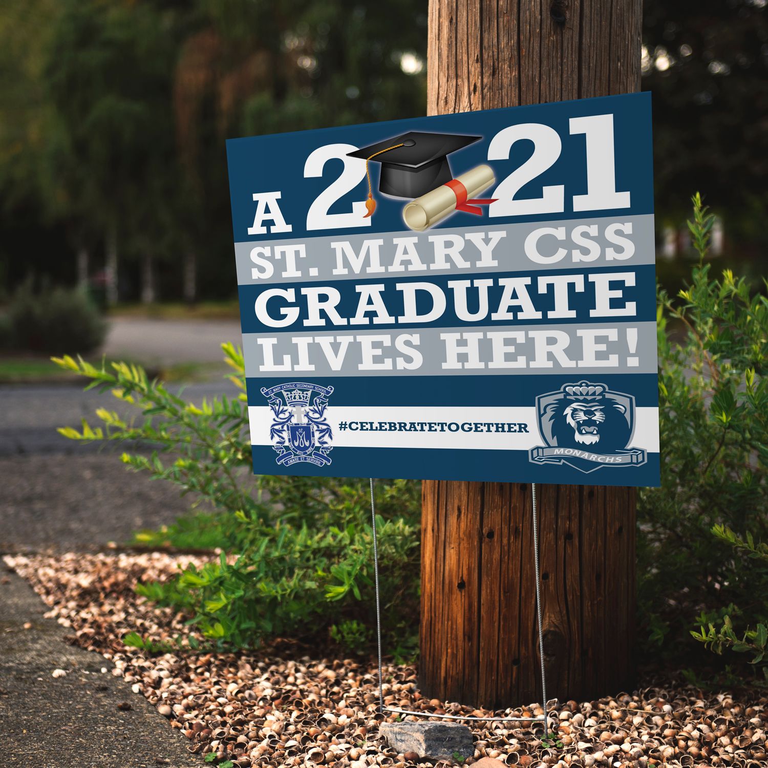 Yard Sign in Front of a Wooden Pole That Says 