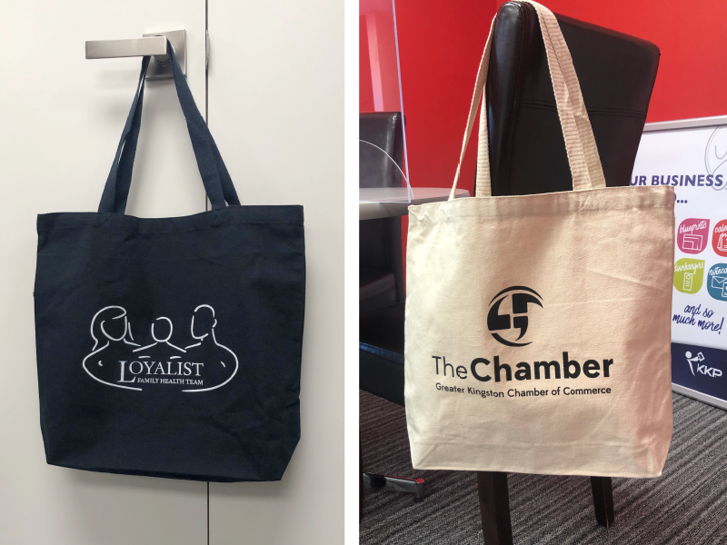 Navy canvas tote with white logo, and natural cotton tote with black logo