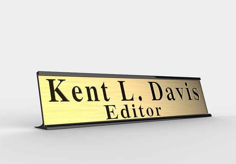 A golden nameplate with the name “Kent L. Davis – Editor” on it. 