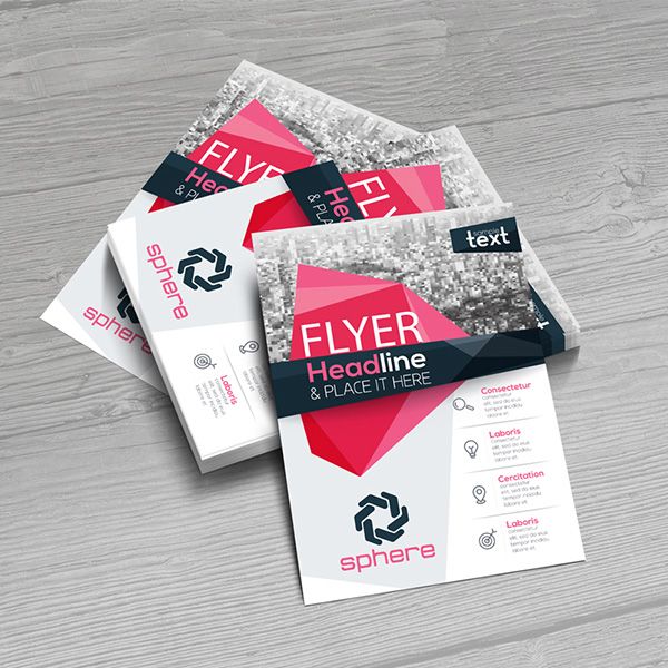 A Stack of Flyer Templates in White, Red, and Black on a Gray Wood Surface