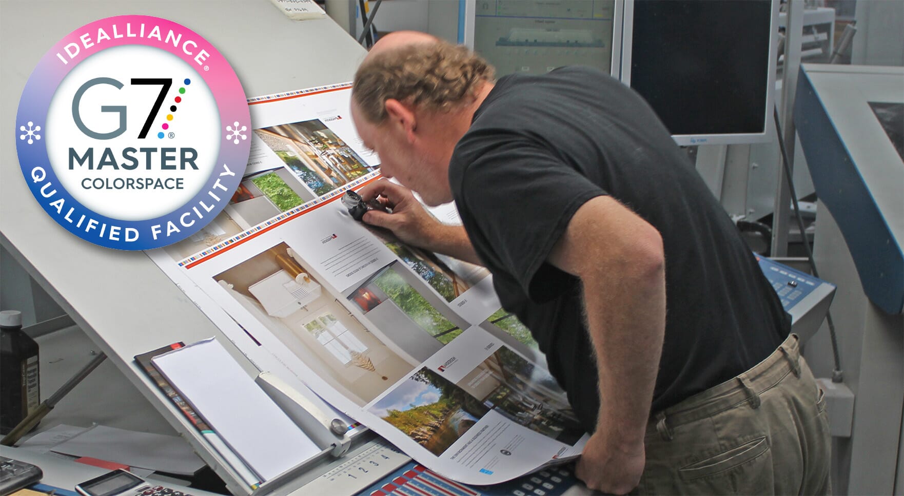 Employee using a color inspecting device to inspect colors with a G7 Certification Badge in the corner