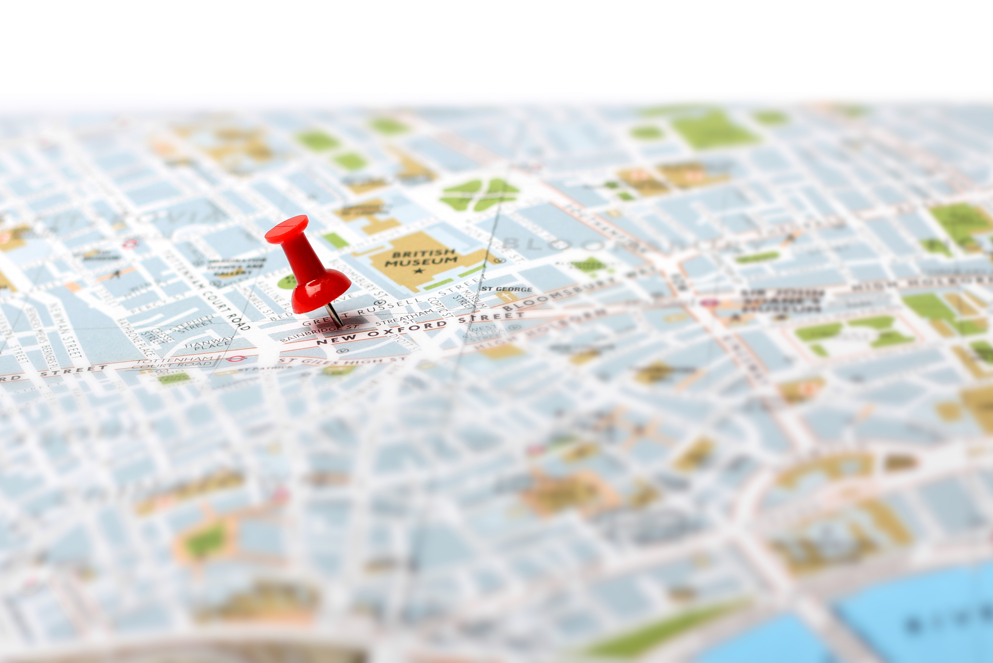 Red push pin pointing planned travel destination on map