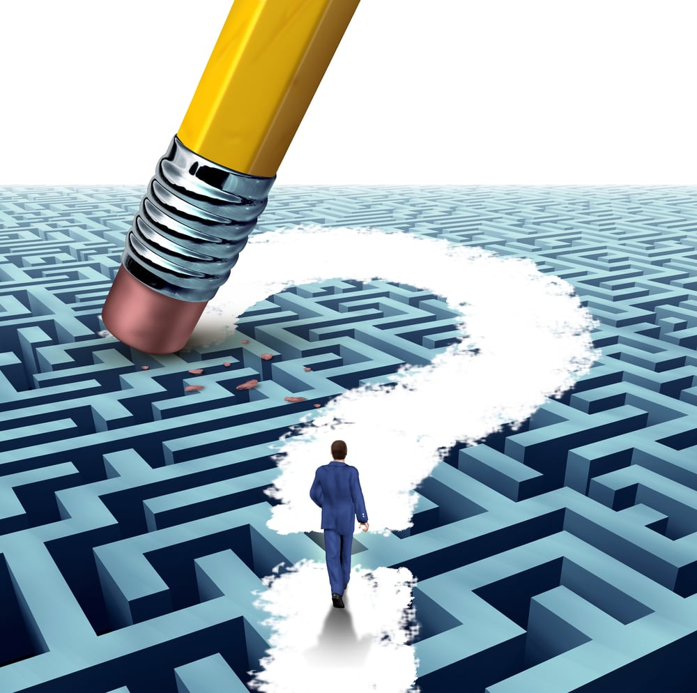 Leadership questions searching for solutions with a businessman walking through a complicated maze opened up by a pencil eraser question mark as a business concept of innovative thinking financial success.