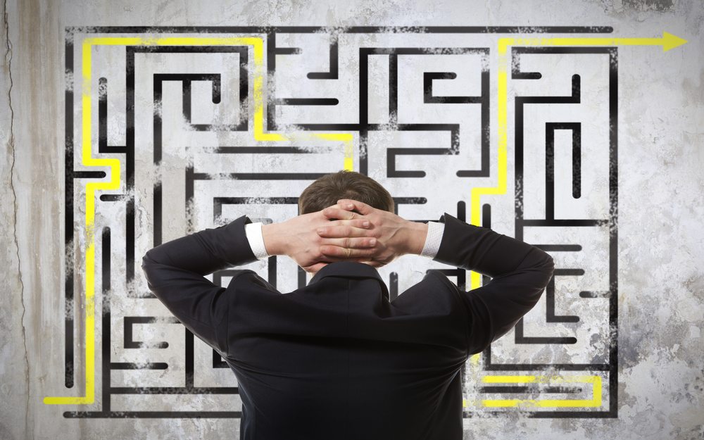 Person frustrated while trying to solve a maze puzzle